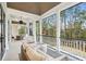 Screened in porch with comfortable seating and a view of the surrounding landscape at 341 Bridgetown Pass, Mount Pleasant, SC 29464