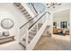 Modern white staircase with metal railing, a light and airy feel at 341 Bridgetown Pass, Mount Pleasant, SC 29464