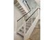 Modern staircase with white risers, dark wood handrail, and metal balusters at 341 Bridgetown Pass, Mount Pleasant, SC 29464