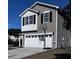 Two-story house with gray siding, white garage door, and basketball hoop at 356 Peters Creek Dr, Summerville, SC 29486