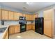 Kitchen with oak cabinets, black appliances, and tile flooring at 356 Peters Creek Dr, Summerville, SC 29486