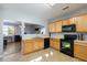 Bright kitchen with oak cabinets, black appliances, and tile flooring at 356 Peters Creek Dr, Summerville, SC 29486