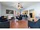 Open living room with hardwood floors, black velvet furniture, and a view of the kitchen at 356 Peters Creek Dr, Summerville, SC 29486