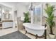 Free-standing bathtub with a chandelier and window at 4263 Persimmon Woods Dr, North Charleston, SC 29420