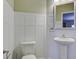 Modern powder room with pedestal sink and white wainscoting at 484 Whispering Breeze Ln, Summerville, SC 29486