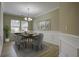 Elegant dining room with chandelier, hardwood floors, and built-in wainscoting at 484 Whispering Breeze Ln, Summerville, SC 29486