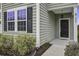 Front entrance with black door and gray siding at 484 Whispering Breeze Ln, Summerville, SC 29486