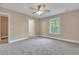 Spacious bedroom with carpet flooring, ceiling fan, and large window at 519 Travelers Blvd, Summerville, SC 29485