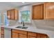 Kitchen features double sink, wood cabinets, and granite countertops at 519 Travelers Blvd, Summerville, SC 29485