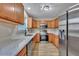 Modern kitchen with wood cabinets, granite countertops, and stainless steel appliances at 519 Travelers Blvd, Summerville, SC 29485