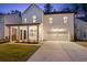 Two-story white house with gray roof, front porch, and attached garage at night at 530 Richfield Way, Summerville, SC 29486