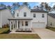 Two-story white house with gray roof, front porch, and attached garage at 530 Richfield Way, Summerville, SC 29486