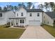Two-story white house with gray roof, front porch, and attached garage at 530 Richfield Way, Summerville, SC 29486