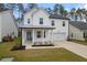 Two-story white house with gray roof, front porch, and attached garage at 530 Richfield Way, Summerville, SC 29486
