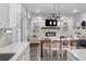 Open concept kitchen and dining area with white cabinets and a farmhouse table at 530 Richfield Way, Summerville, SC 29486