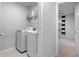 Bright laundry room with washer, dryer, and additional shelving at 530 Richfield Way, Summerville, SC 29486