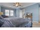 Primary bedroom with TV and blue walls at 705 Quintan St, Summerville, SC 29486