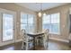 Bright breakfast nook with wooden table and four chairs near sliding door at 705 Quintan St, Summerville, SC 29486