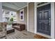 Front porch with wicker furniture, and a dark brown door at 705 Quintan St, Summerville, SC 29486