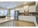 Modern kitchen with white cabinets, granite countertops, and stainless steel appliances at 705 Quintan St, Summerville, SC 29486