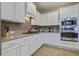 Modern kitchen with white cabinets, granite countertops, and stainless steel appliances at 705 Quintan St, Summerville, SC 29486