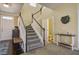 Elegant staircase with dark wood accents and neutral carpeting at 705 Quintan St, Summerville, SC 29486