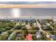 Aerial showcasing beachfront homes at sunset at 904 E Arctic Ave, Folly Beach, SC 29439