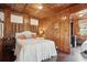 Bedroom with white bedding and wood paneled walls at 904 E Arctic Ave, Folly Beach, SC 29439