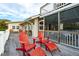 Deck with red Adirondack chairs and footrests, near house entrance at 904 E Arctic Ave, Folly Beach, SC 29439