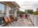 Wooden deck with wooden and red chairs, offering neighborhood views at 904 E Arctic Ave, Folly Beach, SC 29439