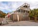 Beach house exterior with multiple decks and surfboard storage at 904 E Arctic Ave, Folly Beach, SC 29439