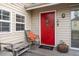 Inviting red front door with nautical details and welcome mat at 904 E Arctic Ave, Folly Beach, SC 29439