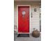 Charming red front door, welcoming guests to the beach home at 904 E Arctic Ave, Folly Beach, SC 29439