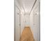 Long hallway with wood floors and doors to bedrooms at 904 E Arctic Ave, Folly Beach, SC 29439