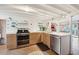 Bright kitchen with stainless steel appliances and light wood cabinets at 904 E Arctic Ave, Folly Beach, SC 29439