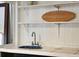 Charming small kitchen sink with blue basin and decorative tile at 904 E Arctic Ave, Folly Beach, SC 29439