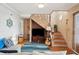 Living area with a TV, couch, and wooden staircase at 904 E Arctic Ave, Folly Beach, SC 29439