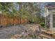 Large backyard with a wooden fence and landscaping at 9117 Woodcreek Ct, North Charleston, SC 29406