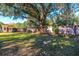 Spacious backyard with mature oak trees, brick wall, and small shed at 927 Fishburne Rd, Pinopolis, SC 29469