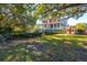 Landscaped backyard with large trees, and seating area at 927 Fishburne Rd, Pinopolis, SC 29469