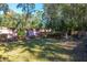 Landscaped backyard with brick wall, lush greenery, and seating areas at 927 Fishburne Rd, Pinopolis, SC 29469