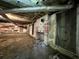Unfinished basement with old fireplace and storage area at 927 Fishburne Rd, Pinopolis, SC 29469
