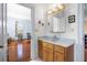 Simple bathroom with wood vanity, sink, and large mirror at 927 Fishburne Rd, Pinopolis, SC 29469