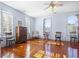 Bedroom with hardwood floors, fireplace, and rocking chairs at 927 Fishburne Rd, Pinopolis, SC 29469