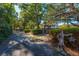 Long driveway leading to home, lined with trees and hedges at 927 Fishburne Rd, Pinopolis, SC 29469
