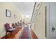 Elegant hallway with hardwood floors, antique chairs, and a grand staircase at 927 Fishburne Rd, Pinopolis, SC 29469