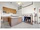 Kitchen boasts wood cabinetry, an island, and a brick fireplace at 927 Fishburne Rd, Pinopolis, SC 29469