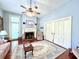Spacious living room with hardwood floors, fireplace, and French doors at 927 Fishburne Rd, Pinopolis, SC 29469