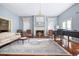 Living room with fireplace, hardwood floors, and ample natural light at 927 Fishburne Rd, Pinopolis, SC 29469