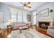 Living room with fireplace, hardwood floors, and a ceiling fan at 927 Fishburne Rd, Pinopolis, SC 29469
